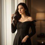 Ultra-realistic 12K cinematic portrait of a young woman with long dark wavy hair standing near a softly lit window, wearing a black off-shoulder dress and delicate necklace, illuminated by warm sunlight through sheer curtains.