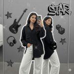 8K ultra-realistic cinematic photograph of a stylish young woman standing in front of a large mirror showing both her front view and reflection. She wears a loose black shirt and white pants with minimal jewelry and soft flowing hair. A white glow outline surrounds both figures, highlighting Gemini’s dual energy. Background features a grayscale collage with an electric guitar, cat face, dice, and “STAR” graffiti, enhanced by artistic lens flares and cinematic lighting.